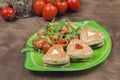 Homemade heart shaped sandwiches with vegetable salad on a plate Royalty Free Stock Photo