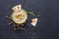 Homemade hummus with pita on black stone table. Middle Eastern traditional and authentic arab cuisine. Top view, flat lay, copy Royalty Free Stock Photo