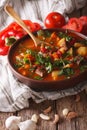 Homemade Hungarian Goulash soup bogracs close-up. Vertical