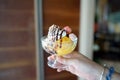 Homemade Ice cream - A bowl of passion fruit sorbet topped with whipped cream, chocolate sauce and meringue. Royalty Free Stock Photo