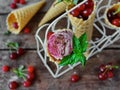 Homemade ice cream cherries and chocolate in a waffle cone, fresh cherries on old wooden table Royalty Free Stock Photo