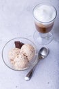 Homemade ice cream with chocolate chips in a bowl. Three balls of ice cream and a cup with coffee. Royalty Free Stock Photo