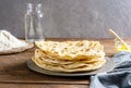 Homemade Indian flat bread Chapati or Roti on wooden background with butter ghee, flour, water and napkin Royalty Free Stock Photo