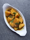 Homemade Indian Taro root  curry or Yam curry on a wooden moody background Royalty Free Stock Photo