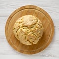 Homemade Irish Soda Bread on a bamboo board on a white wooden surface, top view. Flat lay, overhead, from above. Close-up