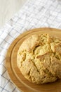 Homemade Irish Soda Bread on a round bamboo board, side view. Copy space