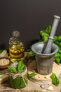 Homemade Italian basil pesto sauce in a vintage mortar with pestle Royalty Free Stock Photo