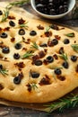 Homemade Italian focaccia with sun dried tomatoes, black olives and rosemary