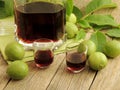 Homemade Italian nocino liqueur with unripe green nuts and alcohol