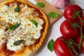 Homemade Italian pizza Napoletana with fresh tomato and garlic sauce, mozzarella cheese and basil leaves Royalty Free Stock Photo