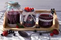 Homemade jam in glass jars with spoon and fresh berries on wooden table Royalty Free Stock Photo