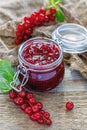Homemade jam in a jar, red currant and old sacking. Royalty Free Stock Photo