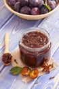 Homemade jam in jar, spices and ripe fruits in wicker basket, healthy sweet dessert Royalty Free Stock Photo