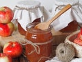 Homemade jams for future use. Amber apple jam in jars on a wooden rustic table with a white background Royalty Free Stock Photo