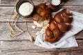 Homemade Jewish traditional challah bread on white napkin on wooden table. Homemade Decorated with poppy seeds. Jewish cuisine. Royalty Free Stock Photo