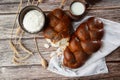 Homemade Jewish traditional challah bread on white napkin on wooden table. Homemade Decorated with poppy seeds. Jewish cuisine. Royalty Free Stock Photo