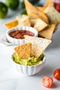 Homemade Keto Tortilla chips in a bowl of guacamole dip with more chips behind. Royalty Free Stock Photo