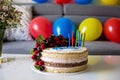 Homemade kids birthday cake with lots of fruits on top, cherries, strawberries, raspberries Royalty Free Stock Photo