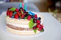 Homemade kids birthday cake with lots of fruits on top, cherries, strawberries, raspberries Royalty Free Stock Photo