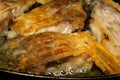 Homemade kitchen. River fish carp, cut into pieces, is fried in pan in cooking oil. Selective focus. Close-up