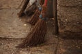 Homemade knitted broom on a wet floor in a rural yard
