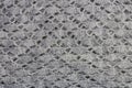 Homemade knitted warm woolen gray scarf wrap texture texture macro