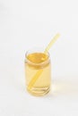 Homemade kombucha fermented drink in glass and straw on white background. Heathy probiotic beverage