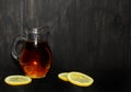 Homemade Kombucha fermented tea in jug with lemon on rustic background, copy space. Heathy natural probiotic drink - kombucha.