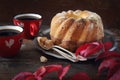 Homemade Kouglof cake, two cups of coffee and autumn red leaves. Royalty Free Stock Photo