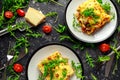 Homemade lasagna with minced beef bolognese and bechamel sauce topped wild arugula, parmesan cheese Royalty Free Stock Photo