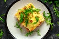 Homemade lasagna with minced beef bolognese and bechamel sauce topped wild arugula, parmesan cheese Royalty Free Stock Photo