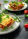 Homemade lasagna with minced beef bolognese and bechamel sauce topped wild arugula, parmesan cheese Royalty Free Stock Photo