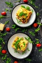 Homemade lasagna with minced beef bolognese and bechamel sauce topped wild arugula, parmesan cheese Royalty Free Stock Photo