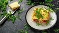 Homemade lasagna with minced beef bolognese and bechamel sauce topped wild arugula, parmesan cheese Royalty Free Stock Photo