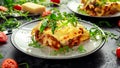 Homemade lasagna with minced beef bolognese and bechamel sauce topped wild arugula, parmesan cheese Royalty Free Stock Photo