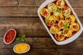 Homemade lasagna rolls in a baking dish on a wooden background. Top view Royalty Free Stock Photo