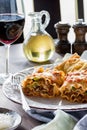 Homemade lasagna rolls ups for dinner served with red wine and garlic toast Royalty Free Stock Photo