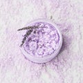 Homemade lavender body scrub in a bowl on lavender bath salt background. Top view, copy space. SPA concept Royalty Free Stock Photo