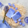 Homemade lavender soap bars and candy shaped soap, lavender extract bottle and dry lavender flowers.