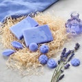 Homemade lavender soap bars and candy shaped soap, lavender extract bottle and lavender flowers. Top view Royalty Free Stock Photo