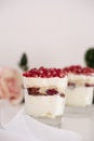 Homemade layered dessert with mascarpone, chocolate, cream, fresh strawberries, cookies, pomegranate. Cheese in a glass. Royalty Free Stock Photo