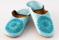 Homemade leather slippers on white background. Pair of blue slipper handmade Royalty Free Stock Photo