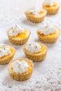 Homemade lemon curd cupcakes with whipped cream on kitchen table Royalty Free Stock Photo