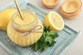 Homemade lemon curd in glass jar with fresh lemons Royalty Free Stock Photo