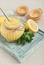 Homemade lemon curd in glass jar with fresh lemons Royalty Free Stock Photo