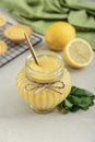 Homemade lemon curd in glass jar with fresh lemons Royalty Free Stock Photo