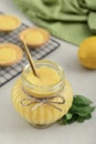 Homemade lemon curd in glass jar with fresh lemons Royalty Free Stock Photo