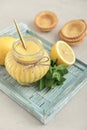 Homemade lemon curd in glass jar with fresh lemons Royalty Free Stock Photo