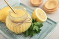 Homemade lemon curd in glass jar with fresh lemons Royalty Free Stock Photo