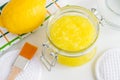 Homemade lemon facial mask exfoliating sugar scrub in the glass jar. Citrus fruit DIY beauty treatment and spa recipe. Top view Royalty Free Stock Photo
